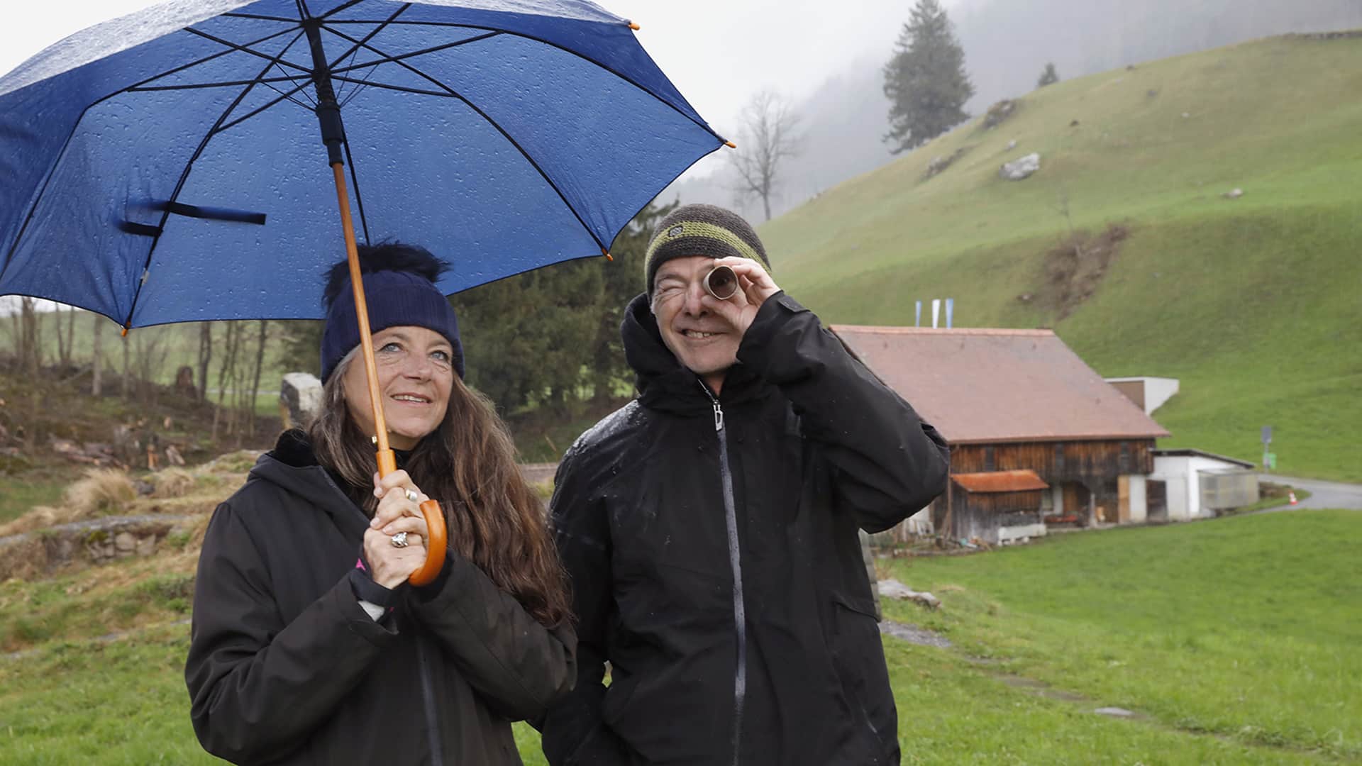 Two people outdoors in the fields of Switzerland