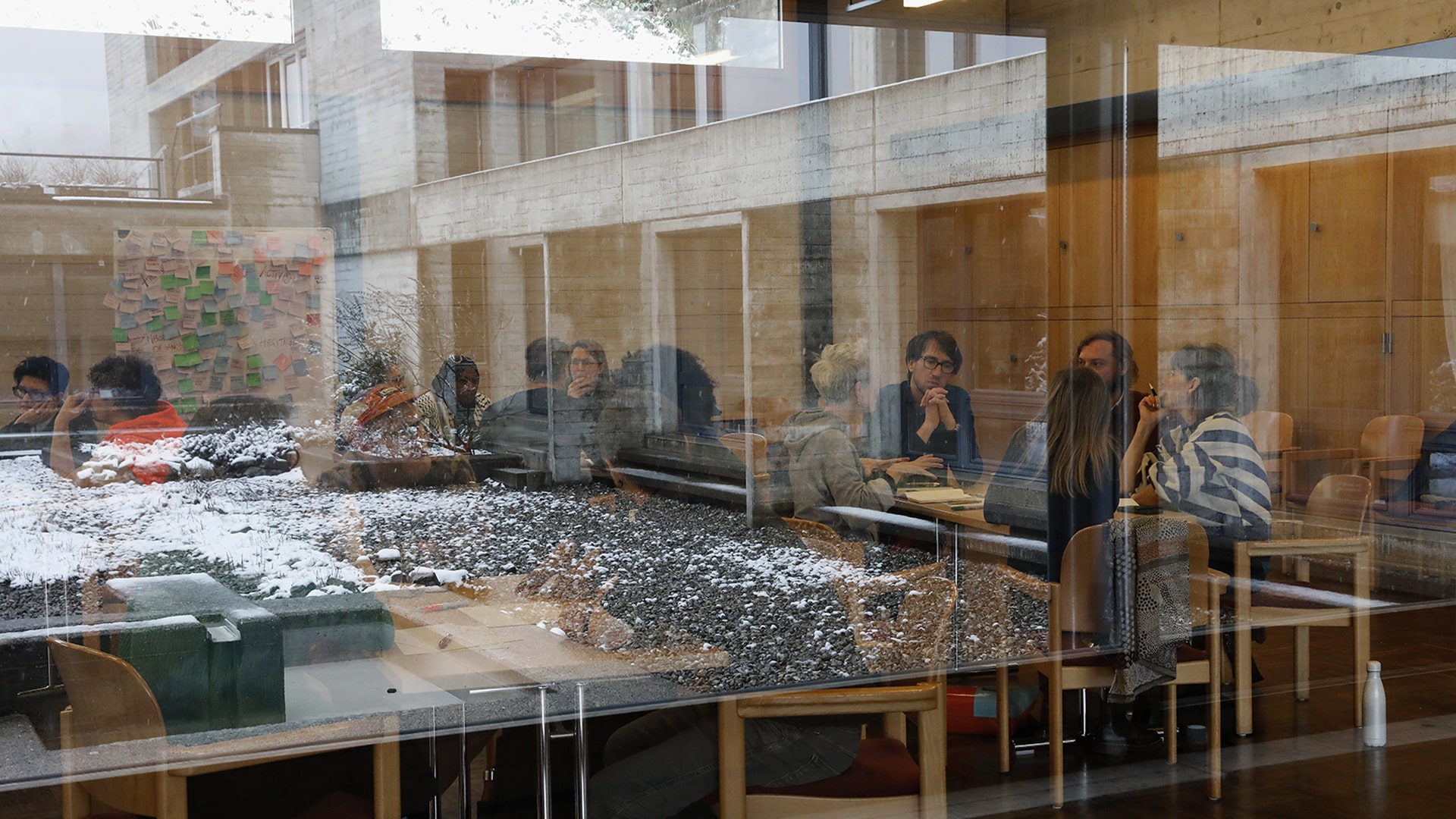 Image of people indoors, shot through glass